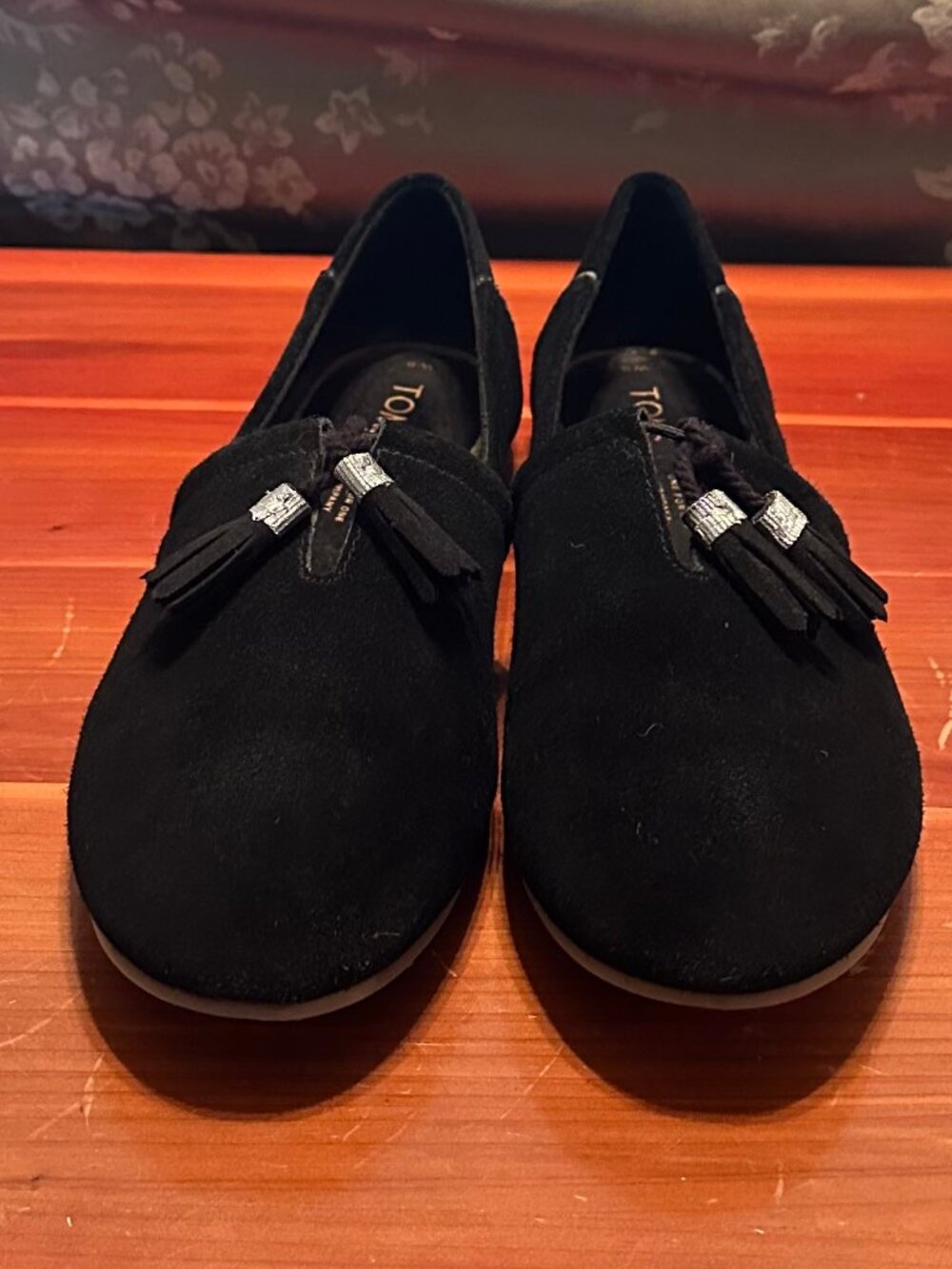 TOMS slip-ons, black suede with silver and black tassels